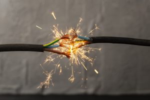 sparks explosion between electrical cables, fire hazard concept, soft focus close up